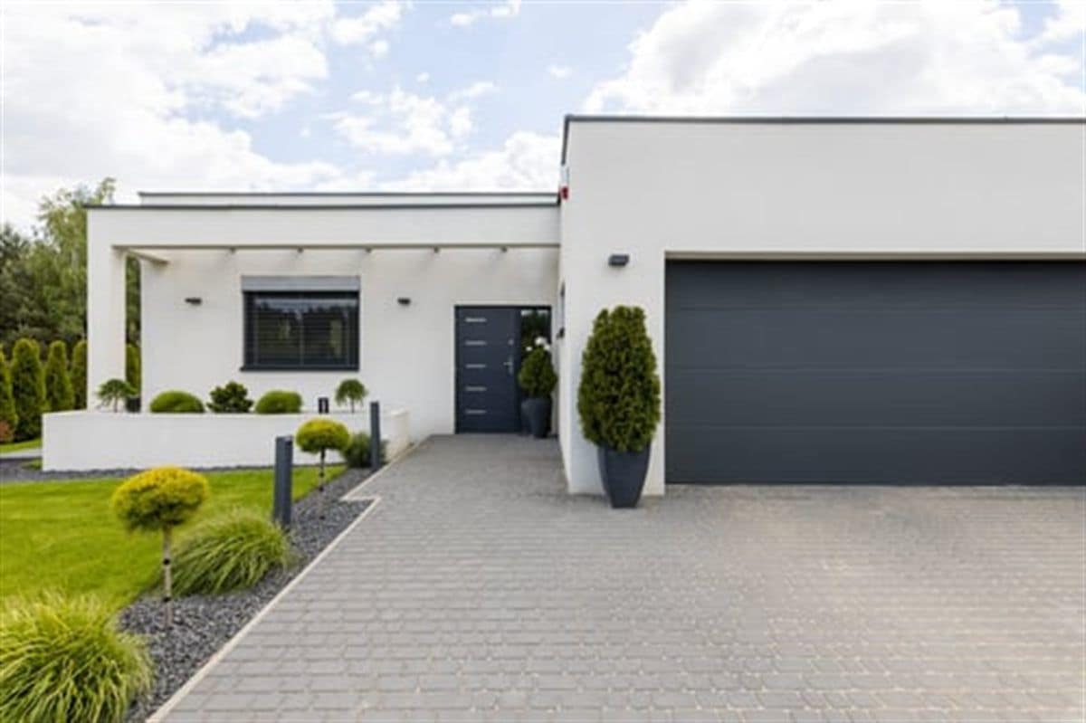 Finished concrete driveway leading to a modern home, poured by Concecret Construction Corp